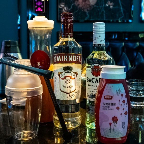 a table topped with bottles of alcohol and glasses